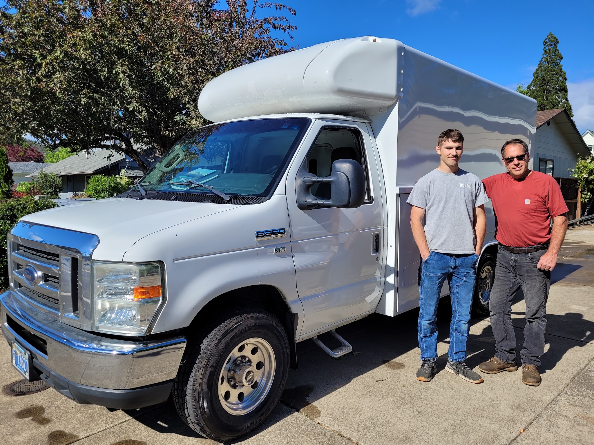 Mike Rokus and his crew beside the company service van in Roseburg, Oregon