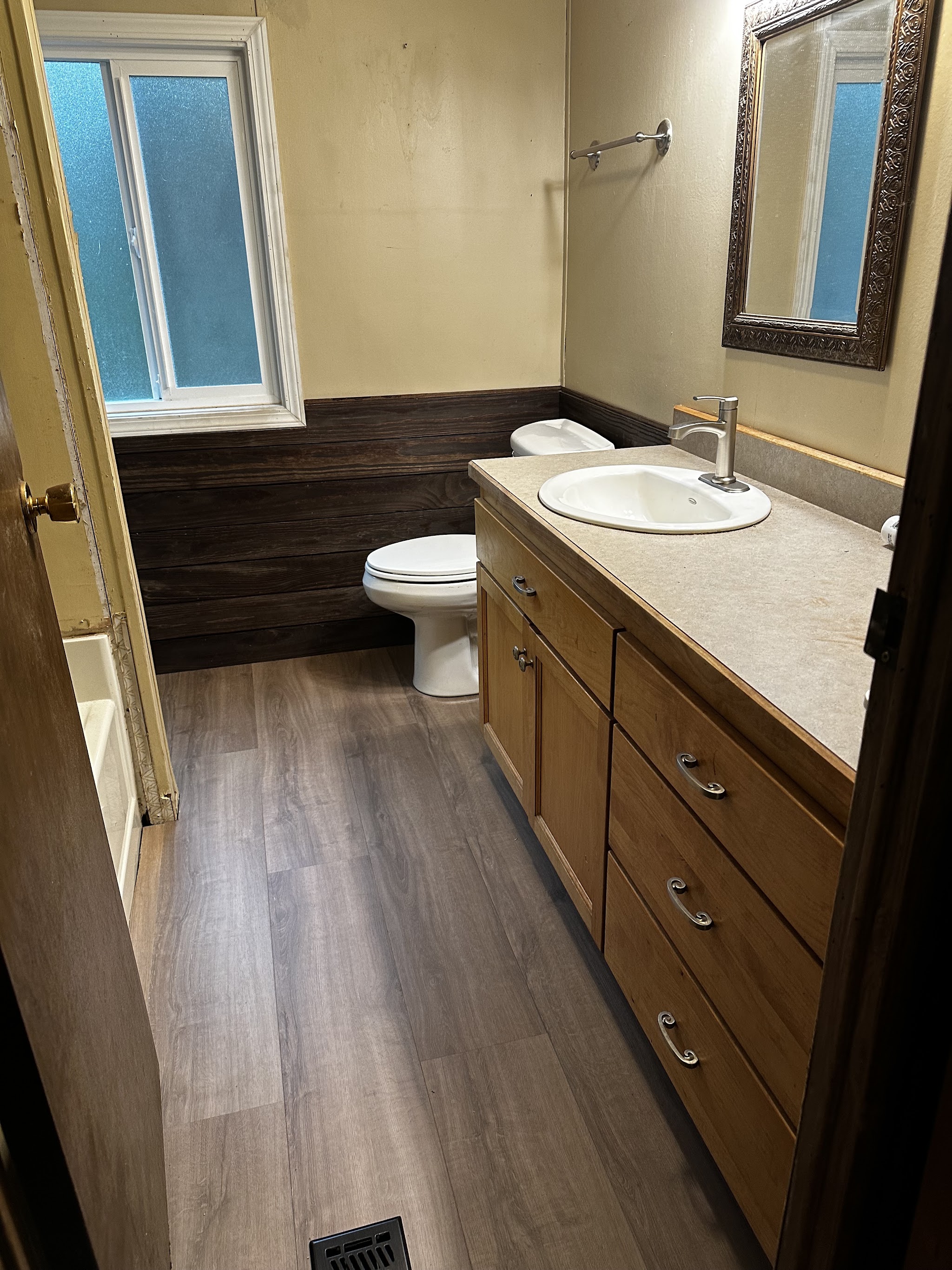 Finished bathroom remodel with new vanity, sink and flooring