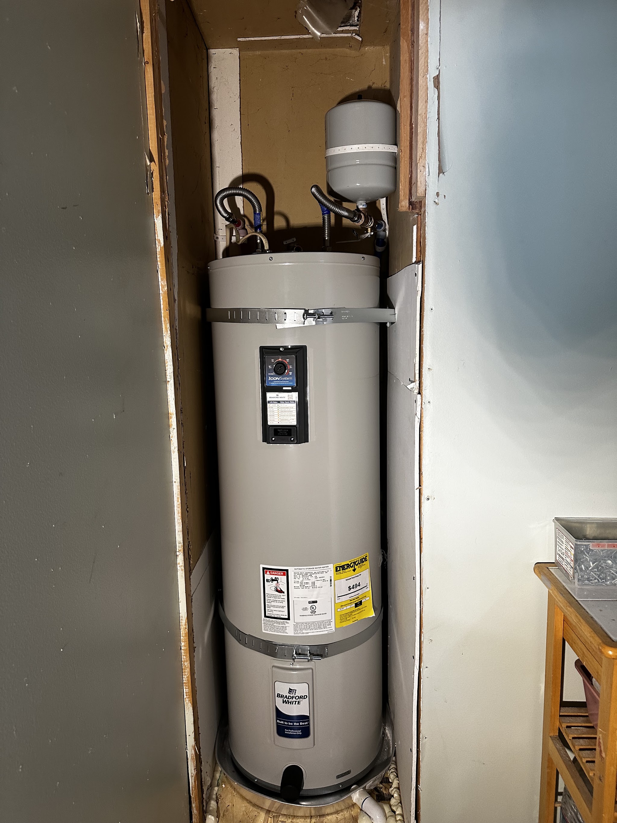 New water heater installed indoors in a utility closet