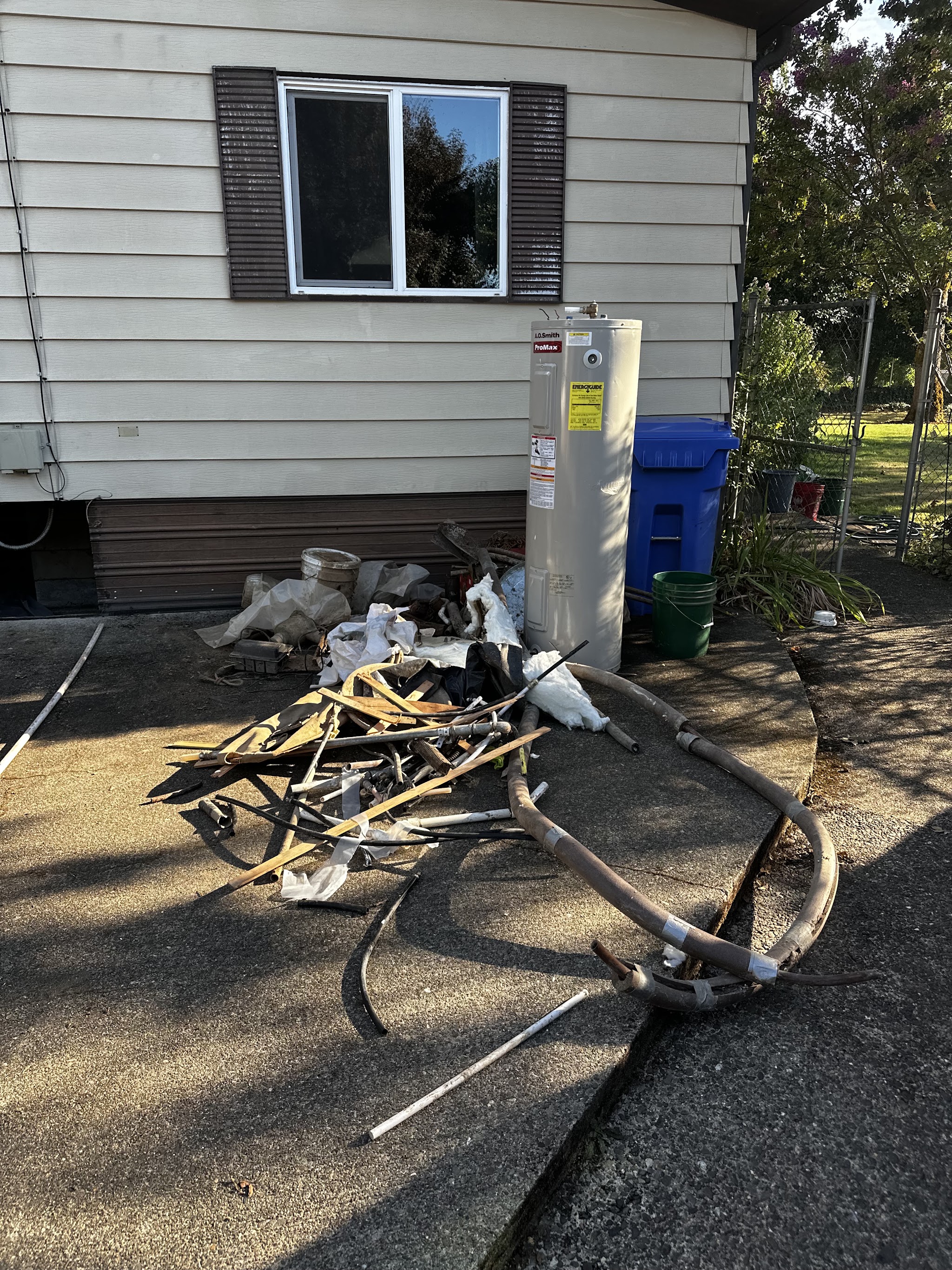 Outdoor water heater installation beside a Roseburg home